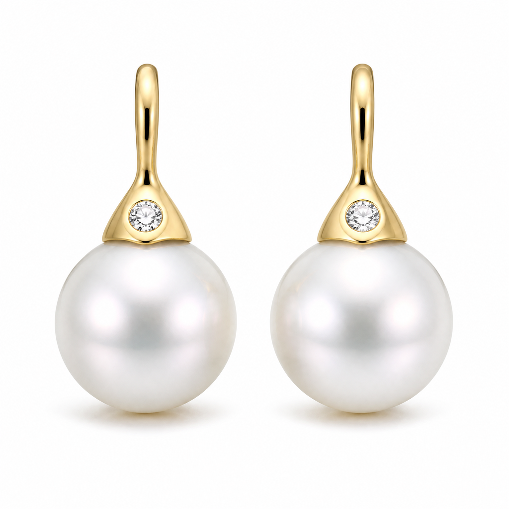 Pearl drop earrings with diamonds in 18K gold on white background