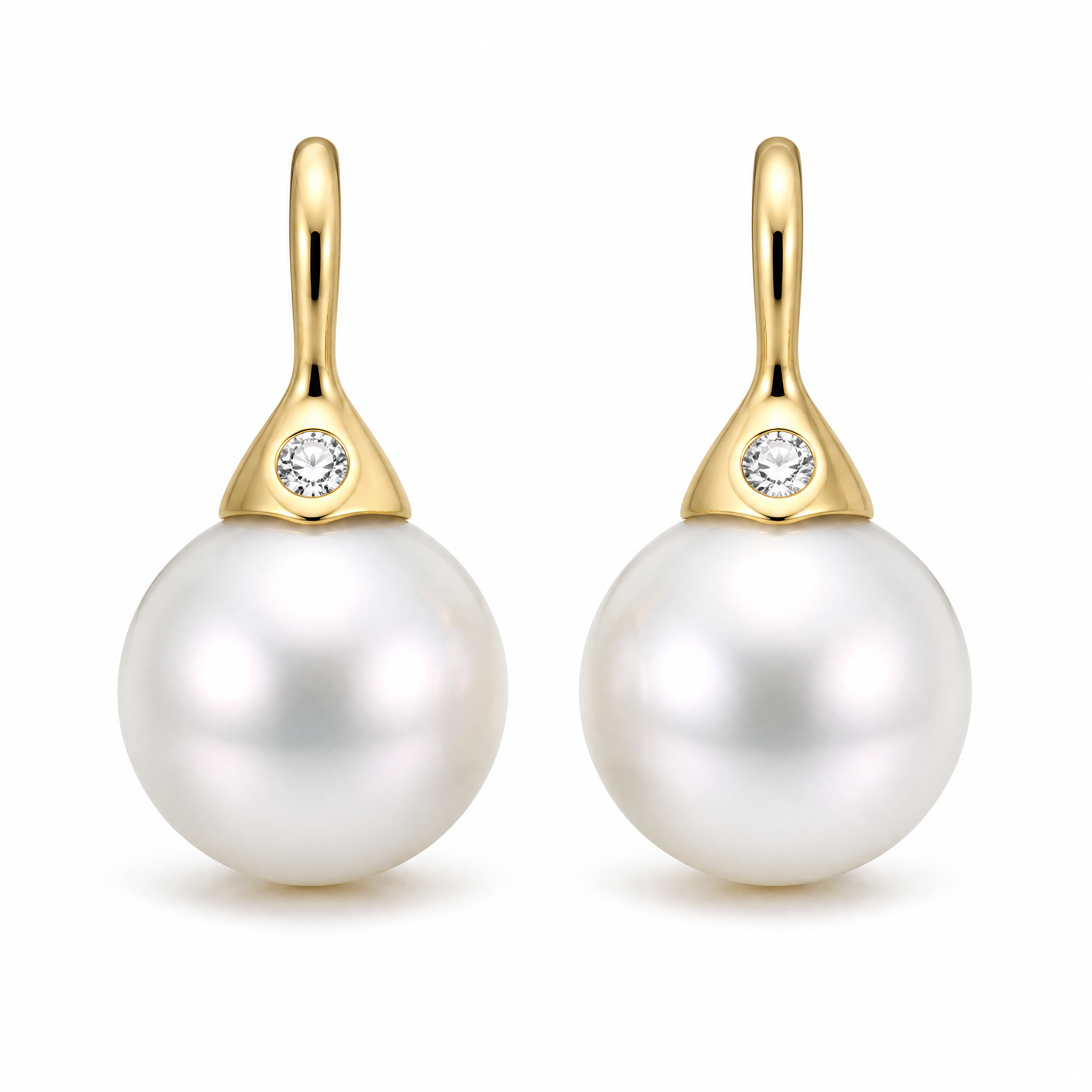 Pearl drop earrings with diamonds in 18K gold on white background